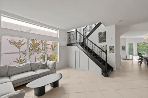 a living room with furniture and stairs