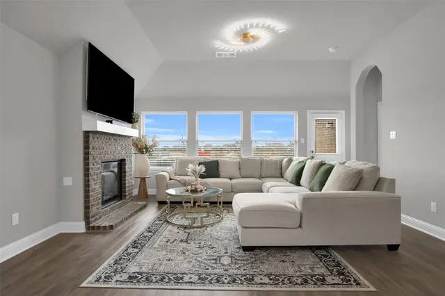 a living room with furniture fireplace and a flat screen tv