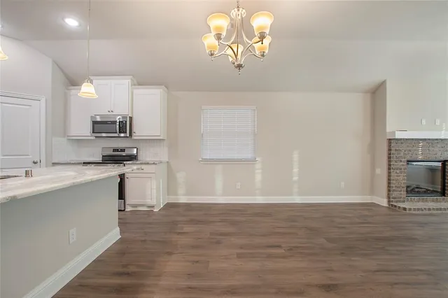 a kitchen with a sink cabinets and wooden floor