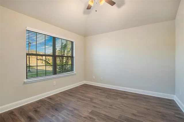 a kitchen with kitchen island granite countertop a sink cabinets and stainless steel appliances