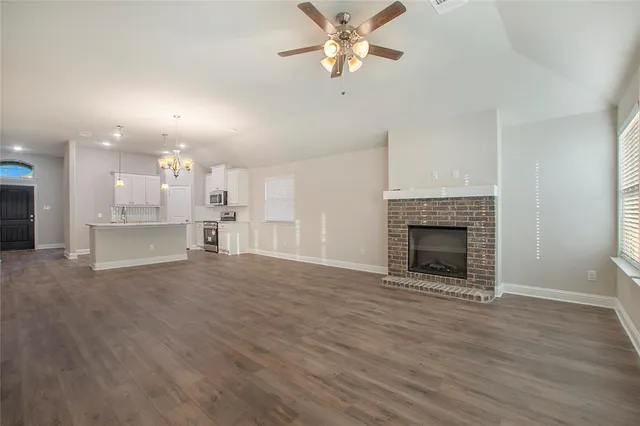 a view of kitchen with refrigerator and wooden floor