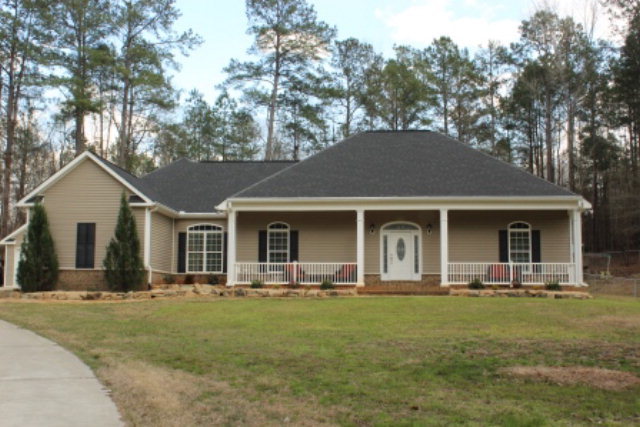 a front view of house with yard and green space