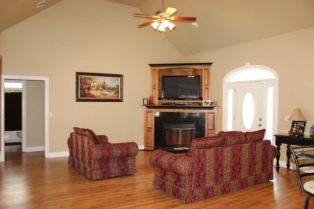 635 Klopfer Road Juliette, GA 31046 - Photo 3 of 18 a living room with furniture a fireplace and a flat screen tv