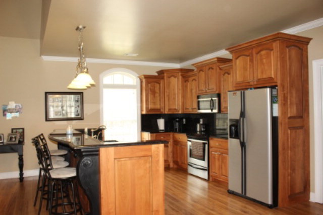635 Klopfer Road Juliette, GA 31046 - Photo 7 of 18 a kitchen with stainless steel appliances granite countertop a refrigerator a stove and a dining table with wooden floor