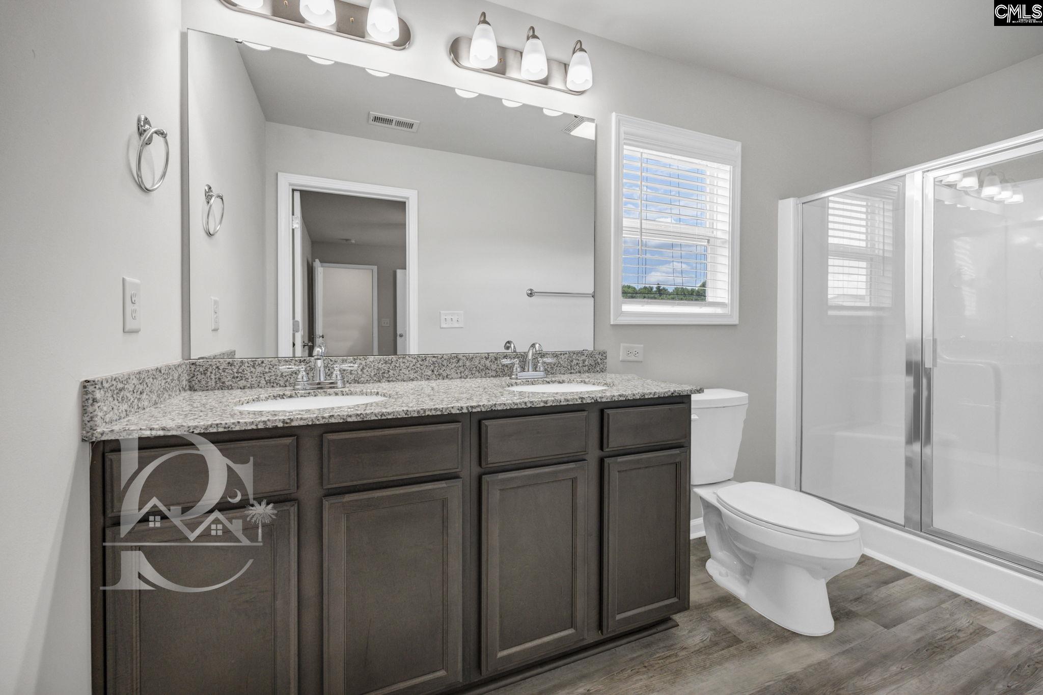 235 Drayton Hall Road West Columbia, SC 29172 - Photo 17 of 24 a bathroom with a granite countertop sink toilet and mirror
