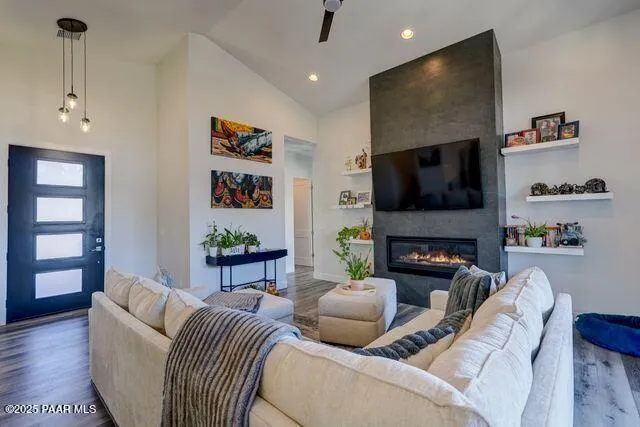 a living room with furniture a flat screen tv and a fireplace