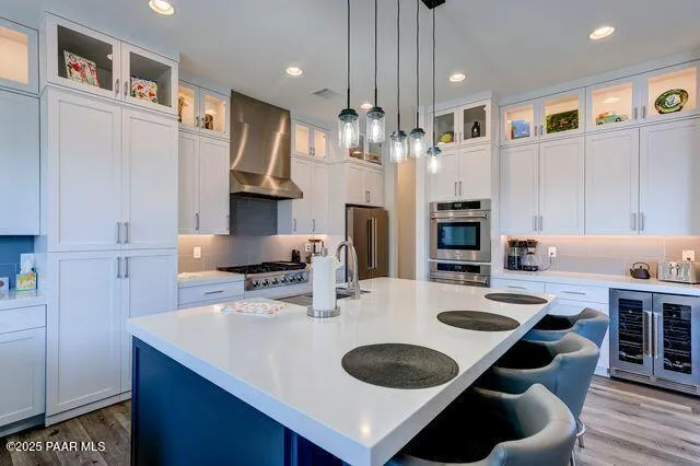 a kitchen with stainless steel appliances granite countertop a sink a stove and a refrigerator