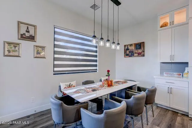 a view of a dining room with furniture wooden floor and chandelier