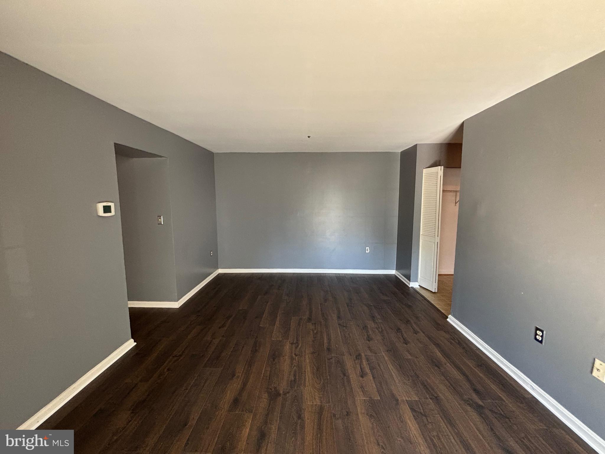 8513 Falls Run Road, Unit A Ellicott City, MD 21043 - Photo 11 of 39 wooden floor in an empty room with a window