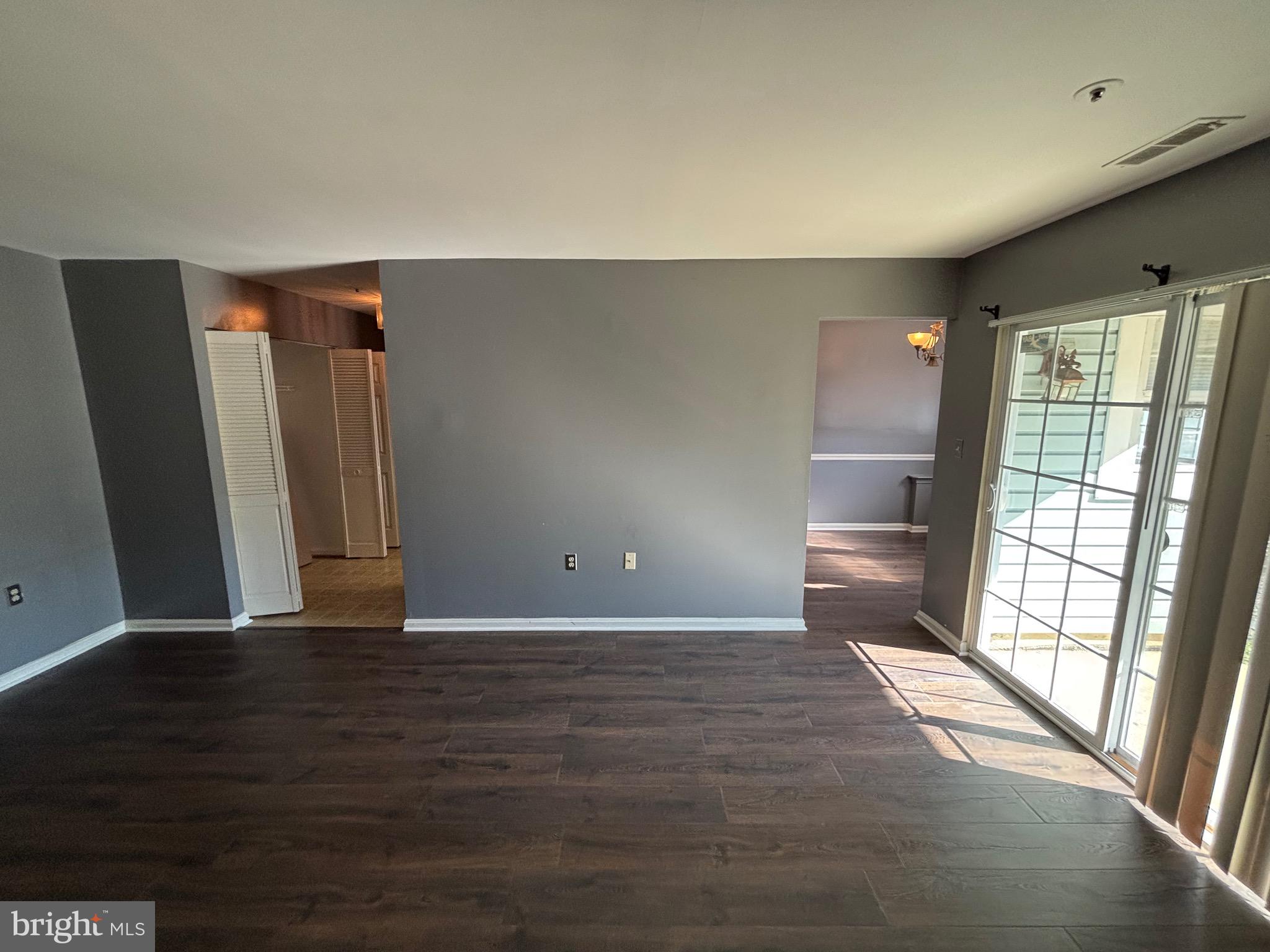8513 Falls Run Road, Unit A Ellicott City, MD 21043 - Photo 12 of 39 a view of an empty room with wooden floor and a window