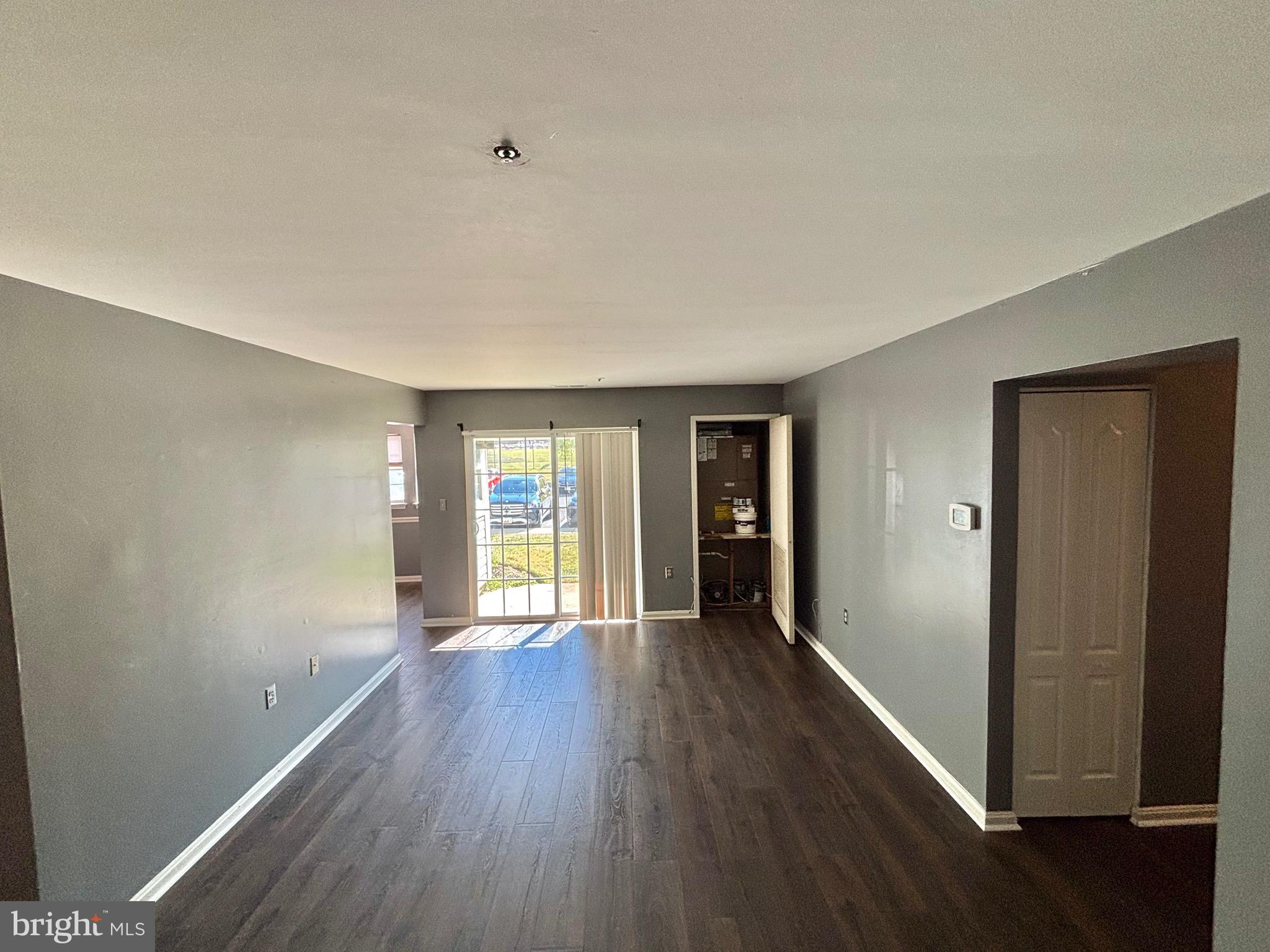 8513 Falls Run Road, Unit A Ellicott City, MD 21043 - Photo 14 of 39 an empty room with wooden floor and windows