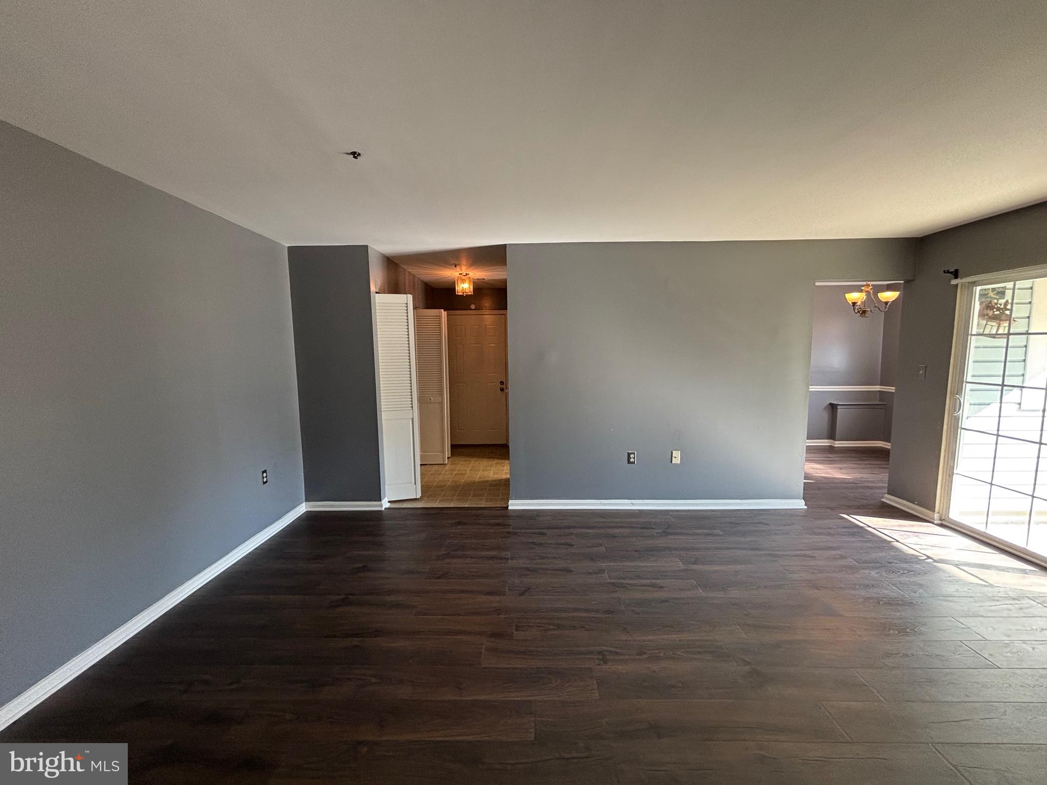 8513 Falls Run Road, Unit A Ellicott City, MD 21043 - Photo 15 of 39 a view of an empty room with window and wooden floor