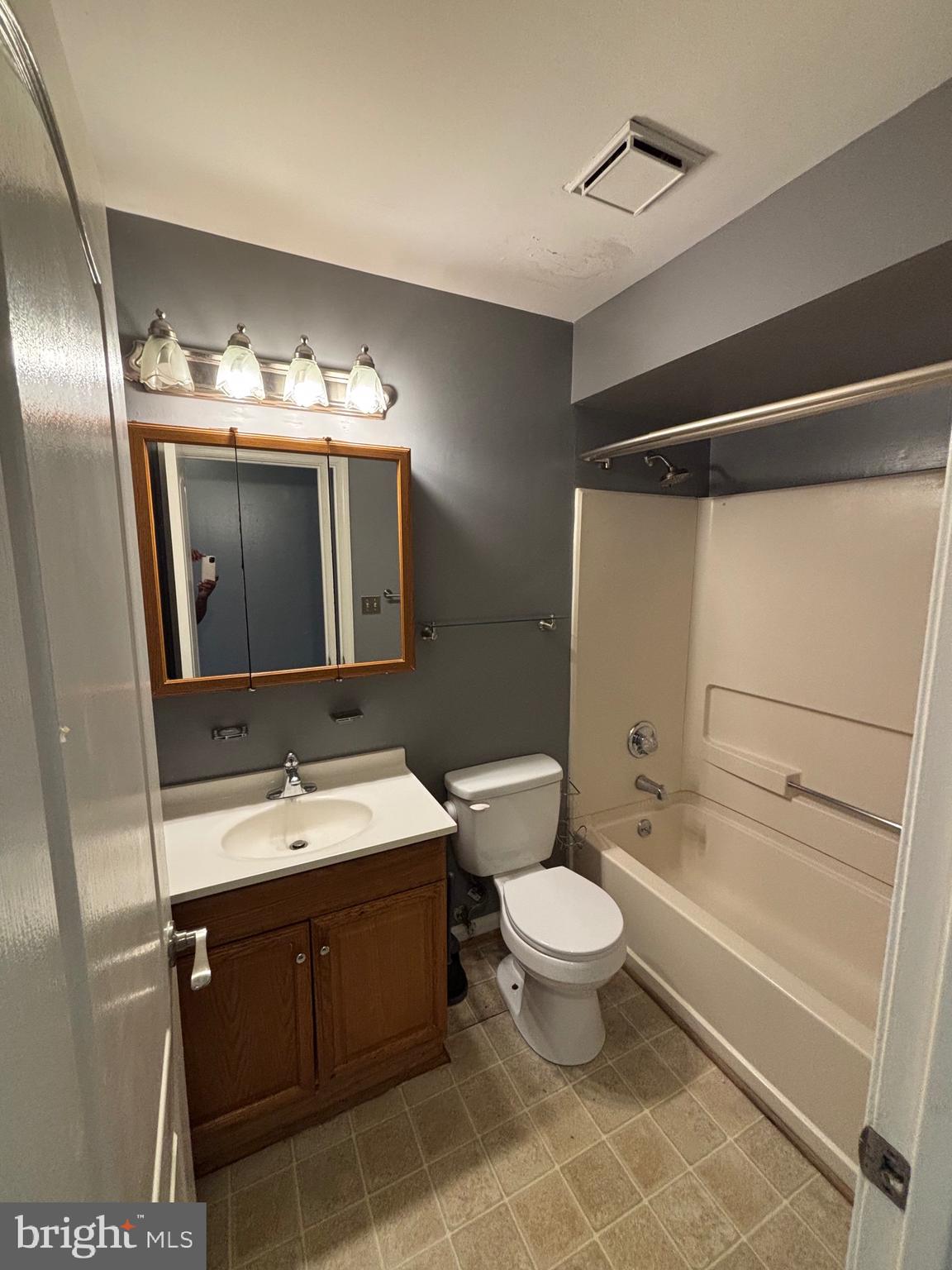 8513 Falls Run Road, Unit A Ellicott City, MD 21043 - Photo 18 of 39 a bathroom with a double vanity sink mirror and toilet