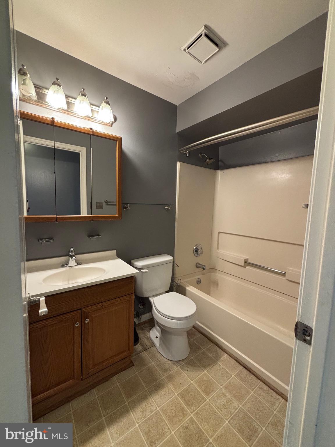 8513 Falls Run Road, Unit A Ellicott City, MD 21043 - Photo 19 of 39 a bathroom with a double vanity sink mirror and toilet
