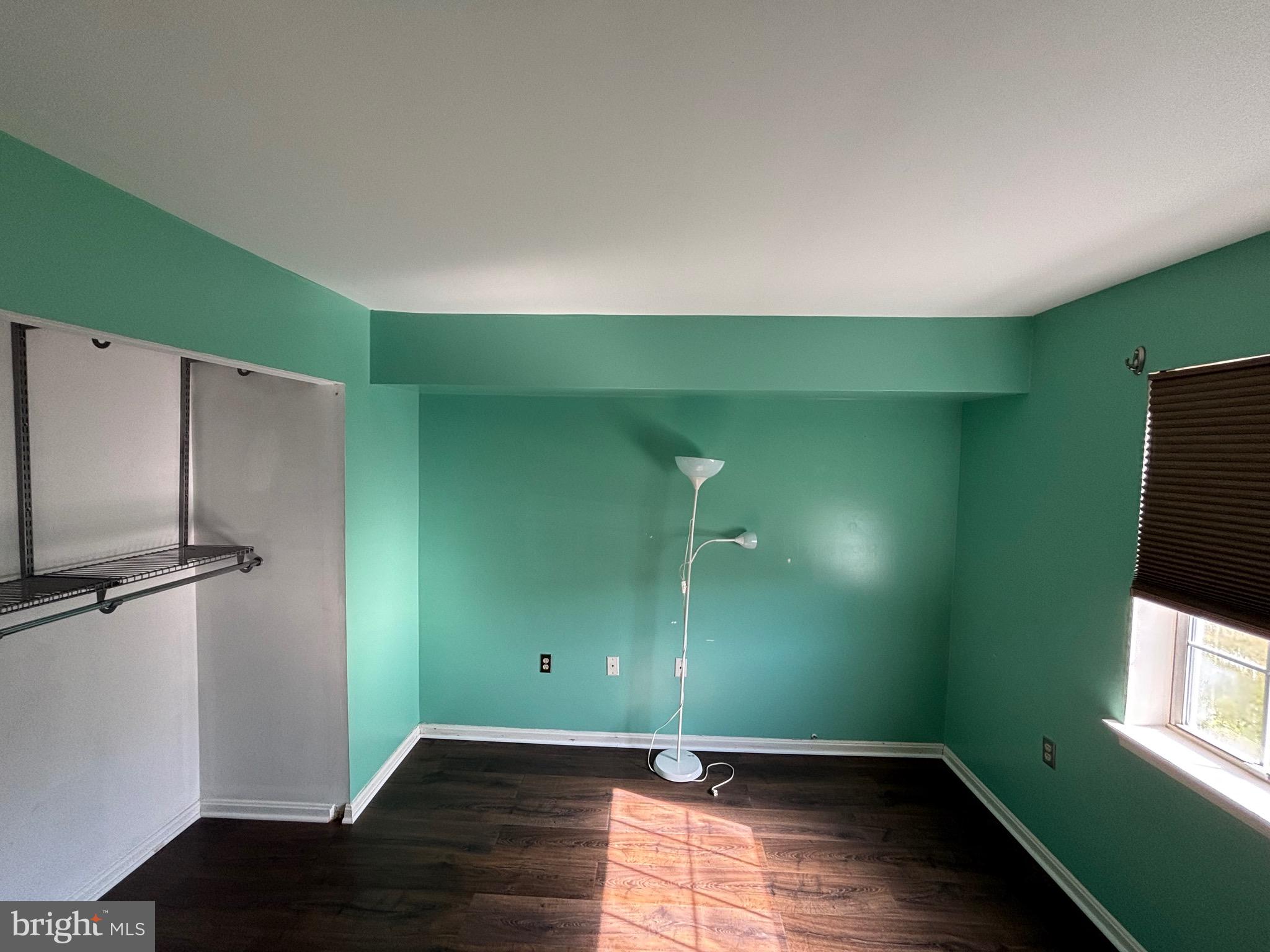 8513 Falls Run Road, Unit A Ellicott City, MD 21043 - Photo 21 of 39 a view of empty room with window and hardwood floor
