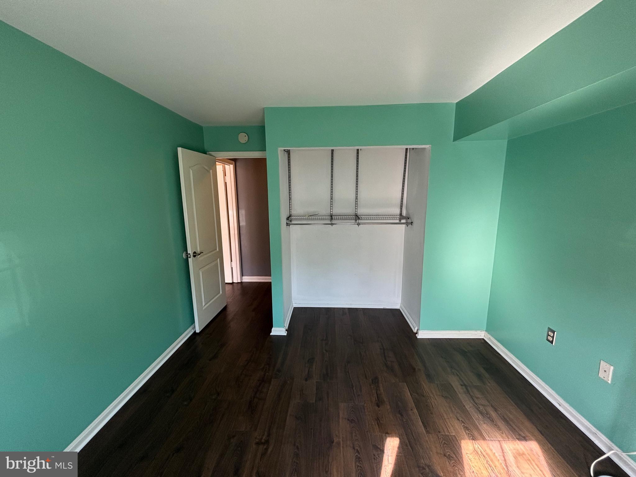 8513 Falls Run Road, Unit A Ellicott City, MD 21043 - Photo 22 of 39 a view of an empty room with wooden floor and a window