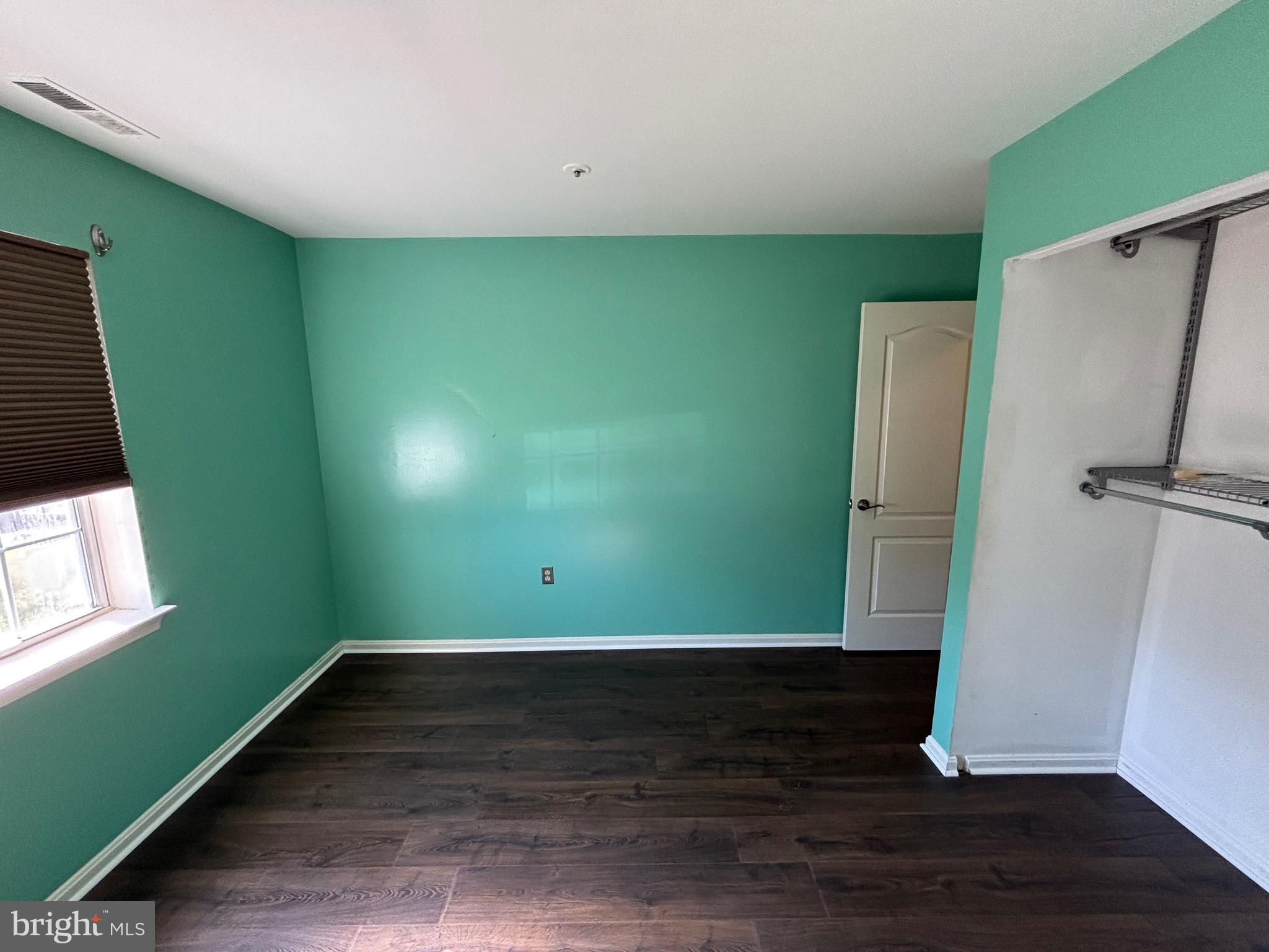8513 Falls Run Road, Unit A Ellicott City, MD 21043 - Photo 24 of 39 a view of an empty room with wooden floor and a window