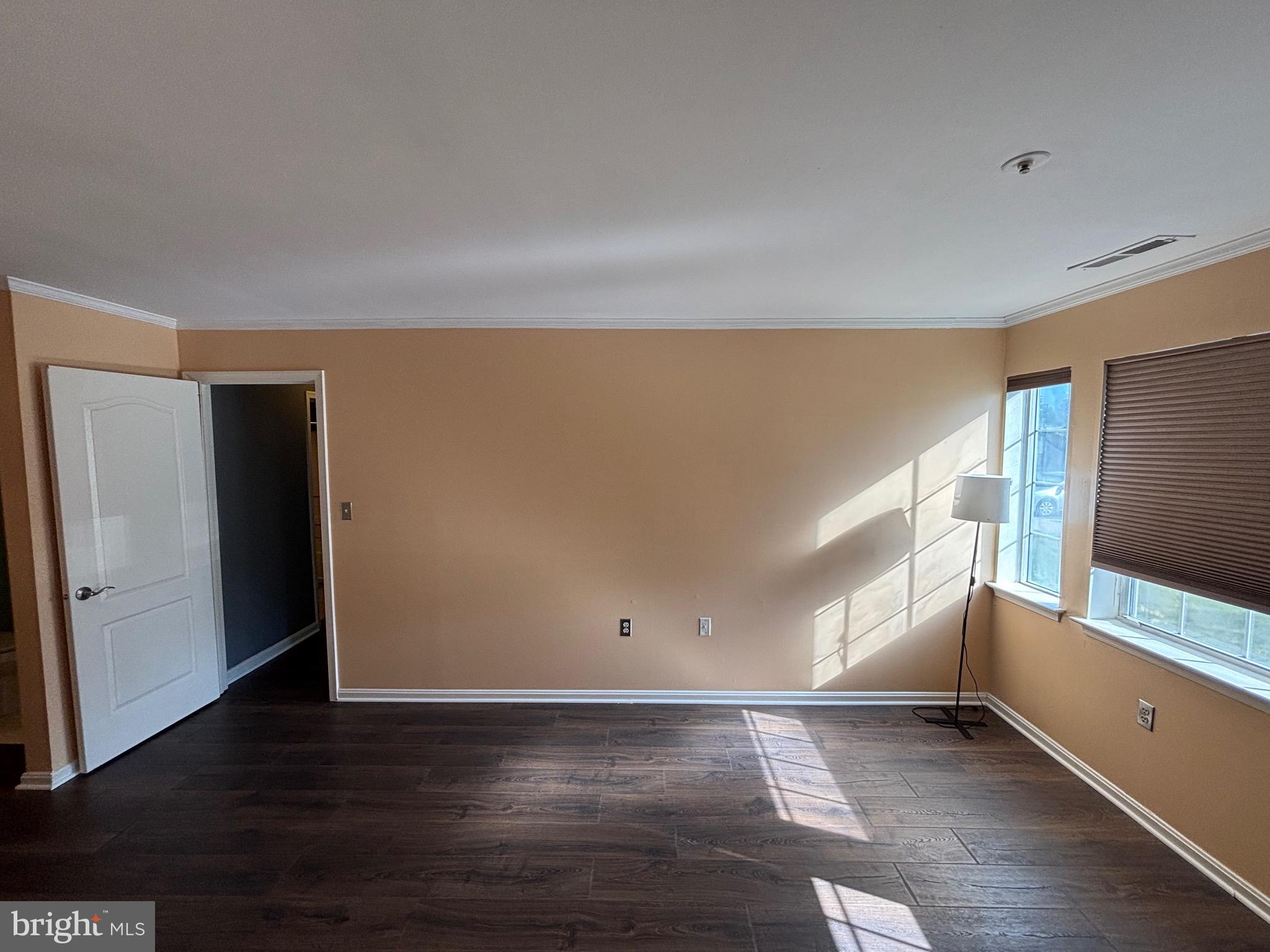 8513 Falls Run Road, Unit A Ellicott City, MD 21043 - Photo 32 of 39 a view of an empty room with wooden floor and a window