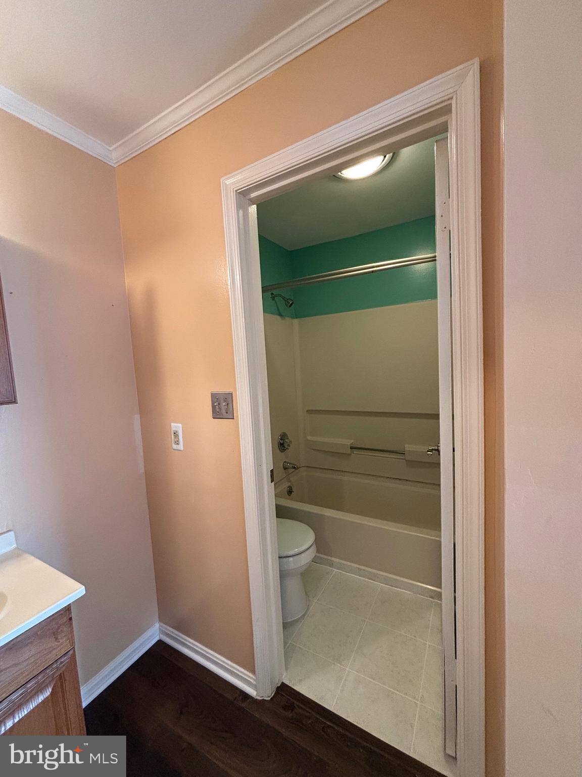 8513 Falls Run Road, Unit A Ellicott City, MD 21043 - Photo 34 of 39 a bathroom with a glass door shower and vanity