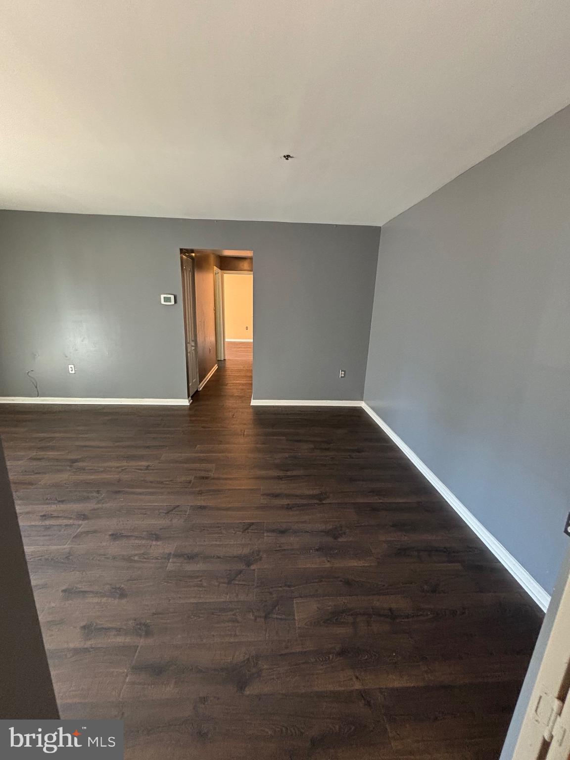 8513 Falls Run Road, Unit A Ellicott City, MD 21043 - Photo 5 of 39 a view of an empty room with wooden floor and windows