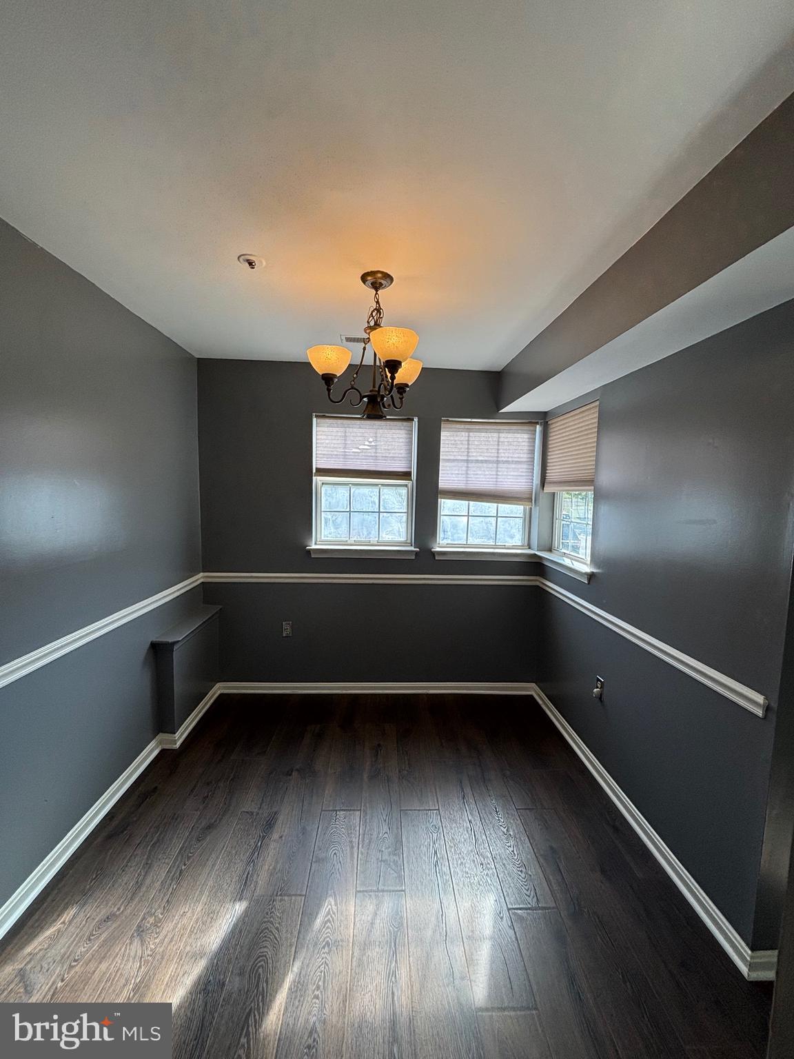 8513 Falls Run Road, Unit A Ellicott City, MD 21043 - Photo 7 of 39 a view of an empty room with wooden floor and a window