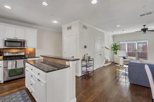 a kitchen with stove and cabinets