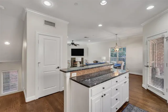 a kitchen with granite countertop a sink and a stove top oven