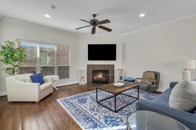 a living room with furniture a fireplace and a flat screen tv
