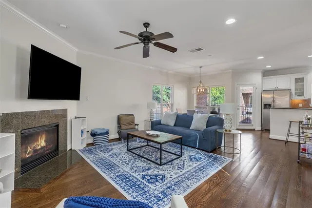 a living room with furniture a flat screen tv and a fireplace