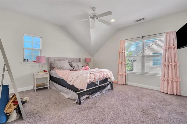a bed room with a bed and a ceiling fan