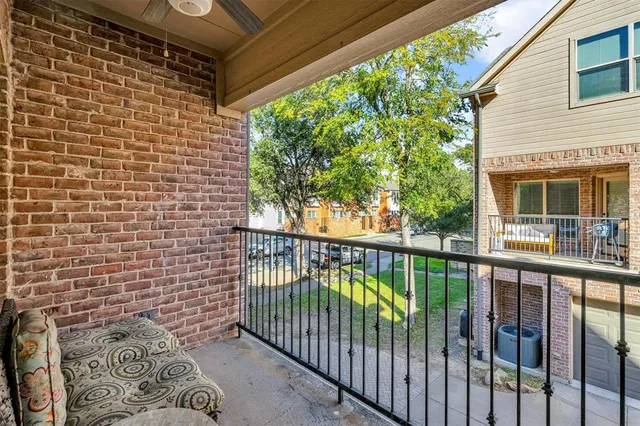 a view of a balcony with next to a yard