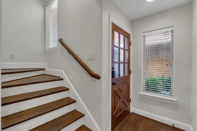 a view of entryway and hall with wooden floor