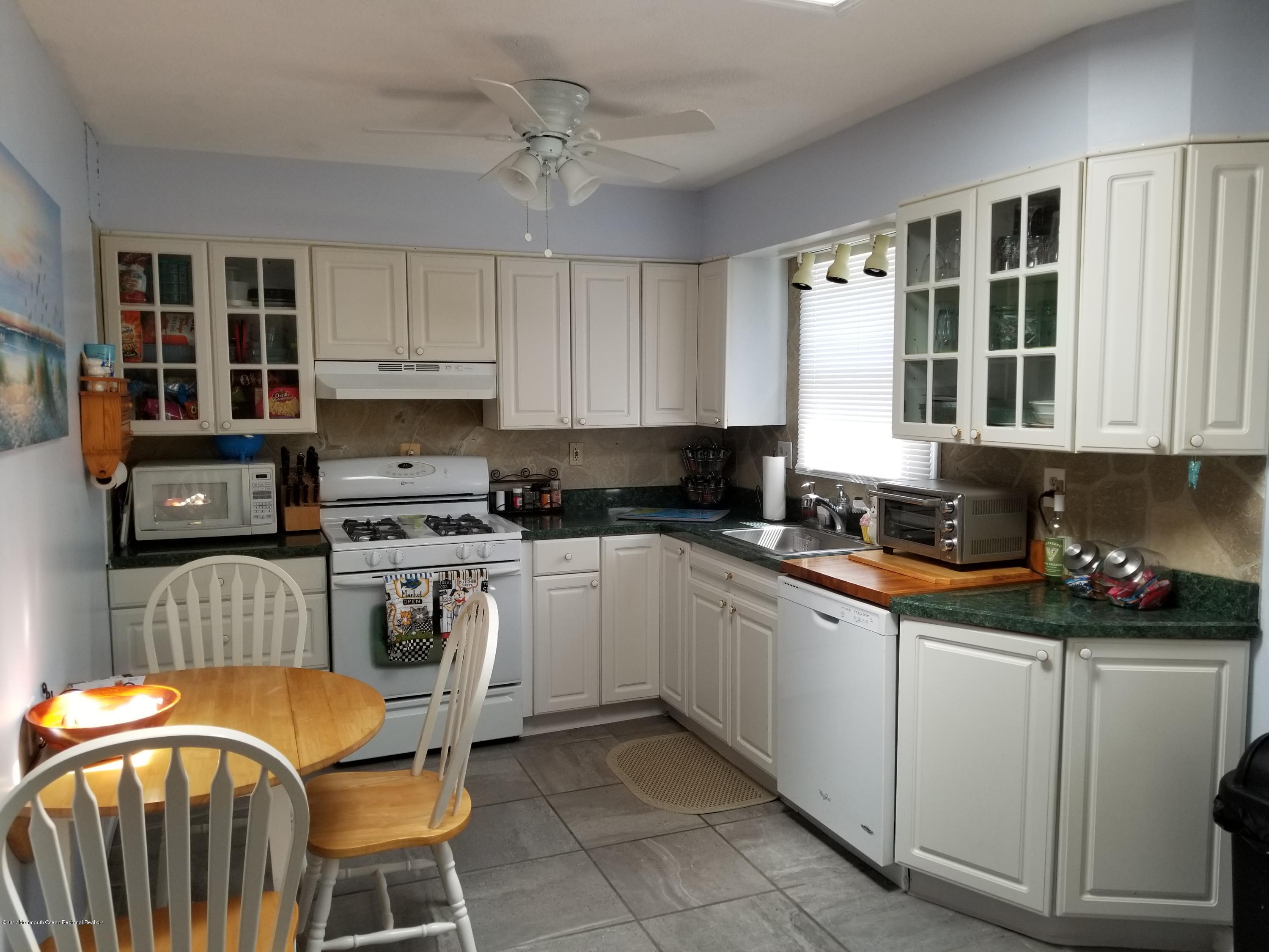 1093 Larsen Road Jackson, NJ 08527 - Photo 3 of 36 a kitchen with stainless steel appliances granite countertop a sink and a stove