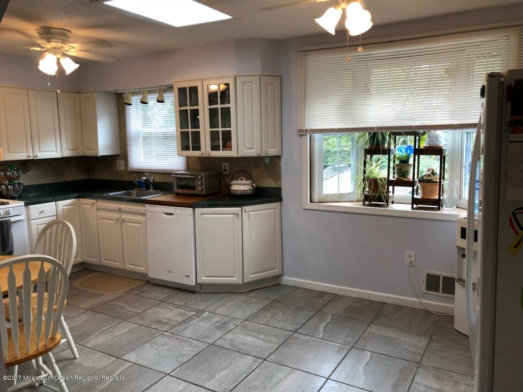 1093 Larsen Road Jackson, NJ 08527 - Photo 6 of 36 a kitchen with a stove a sink and a refrigerator