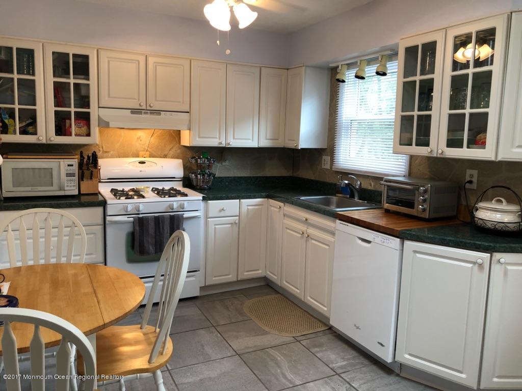 1093 Larsen Road Jackson, NJ 08527 - Photo 8 of 36 a kitchen with granite countertop a stove a sink and a microwave