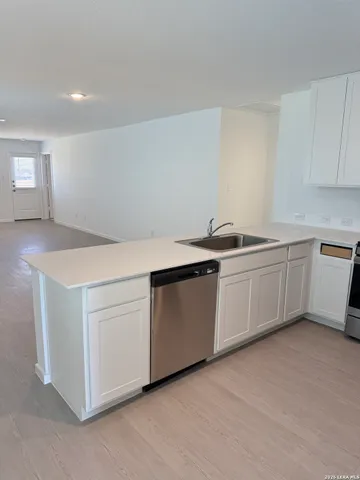 a utility room with a sink washer and dryer