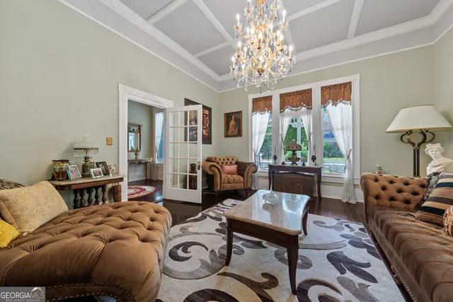 a living room with furniture a flat screen tv and a rug