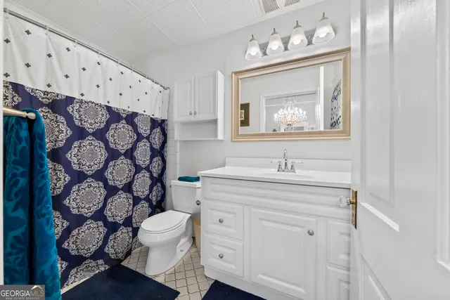 a living room with furniture and a ceiling fan