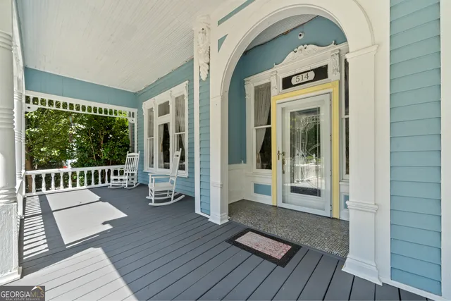 a living room with furniture a fireplace and a chandelier