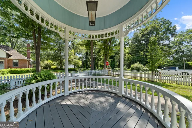a living room with furniture a chandelier a large window and a chandelier