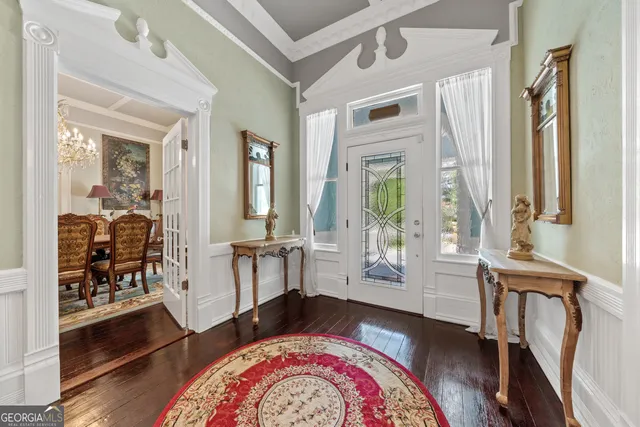 a view of a dining room with furniture and a chandelier
