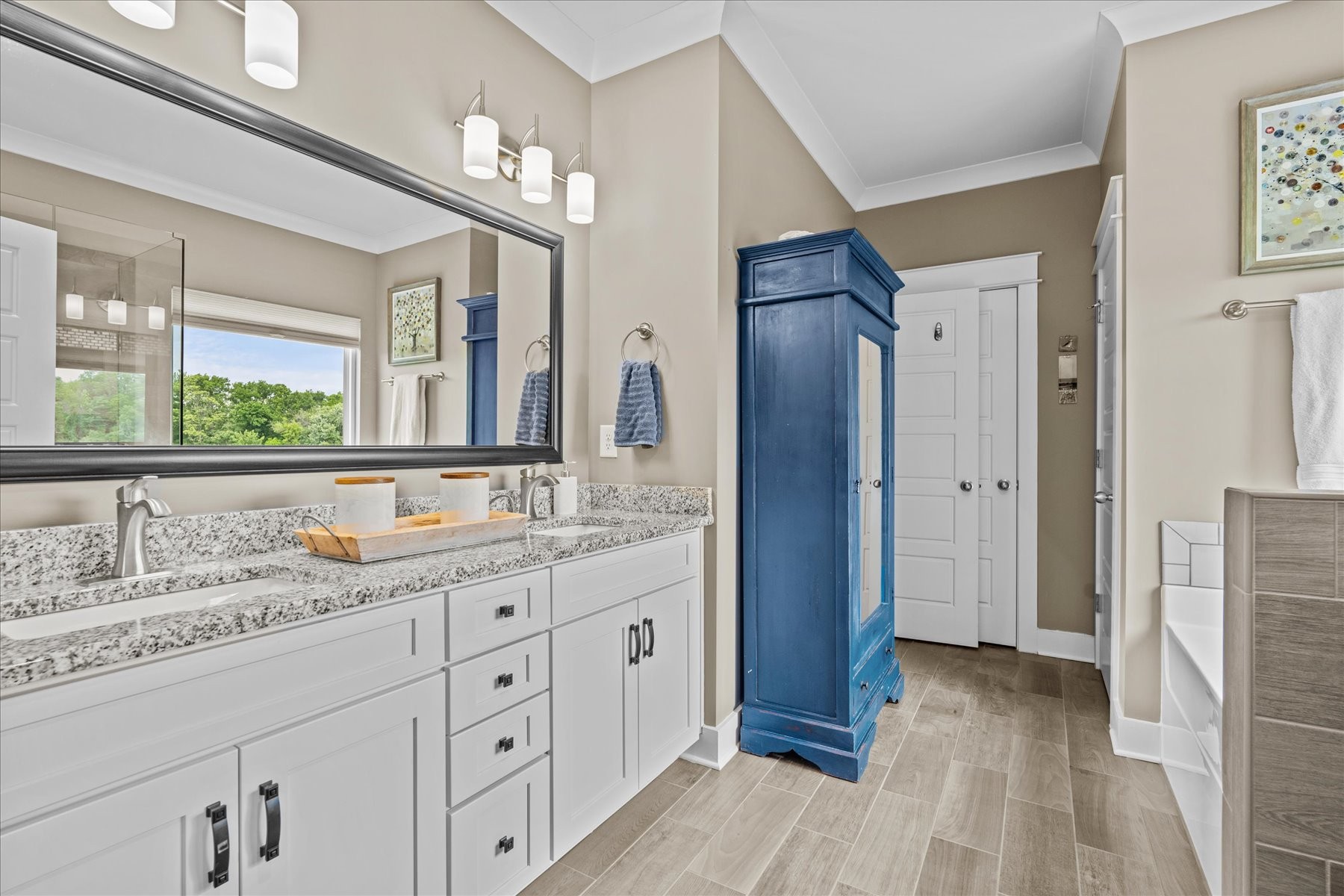 766 Beamon Drive Franklin, TN 37064 - Photo 22 of 39 a bathroom with a granite countertop sink a mirror a vanity and a shower