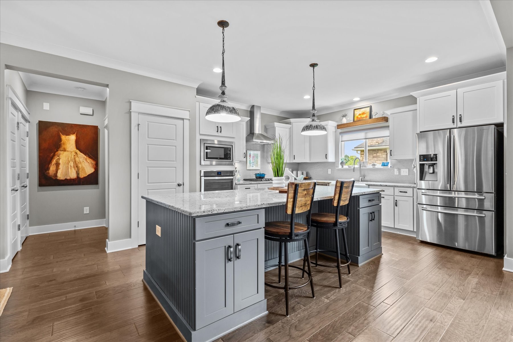 766 Beamon Drive Franklin, TN 37064 - Photo 9 of 39 a kitchen with stainless steel appliances granite countertop a refrigerator a sink dishwasher a dining table and chairs with wooden floor