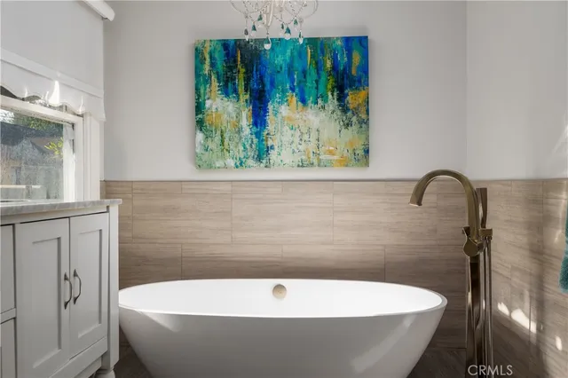 a bathroom with a bathtub and a window