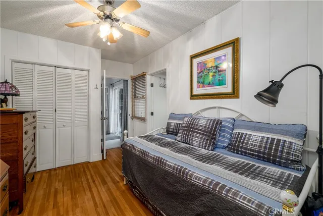 a bedroom with furniture and wooden floor
