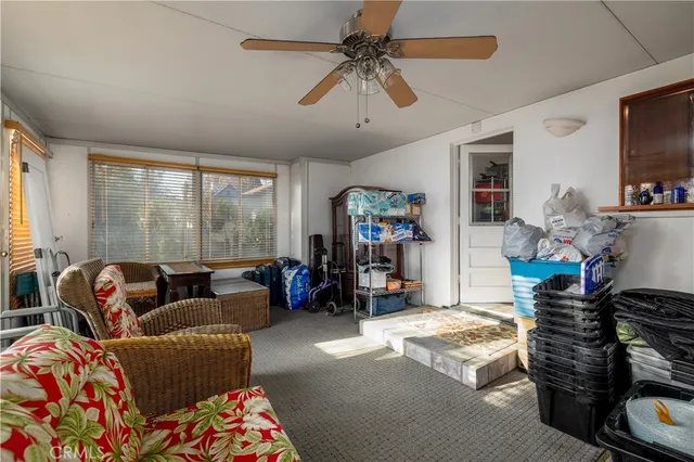 a bedroom with furniture and a large window