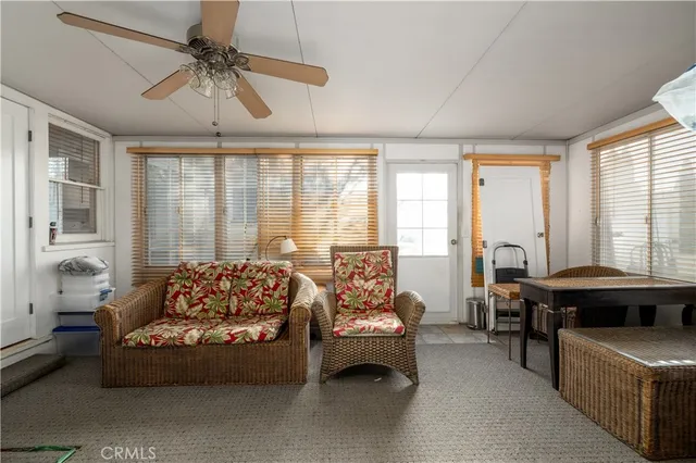 a living room with furniture and large windows