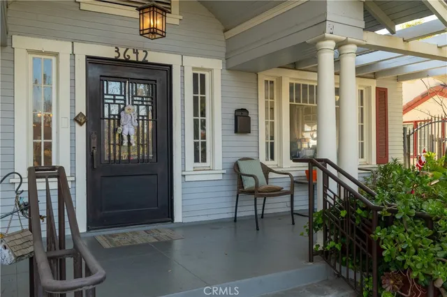 a view of a porch with a table and chairs and potted plants