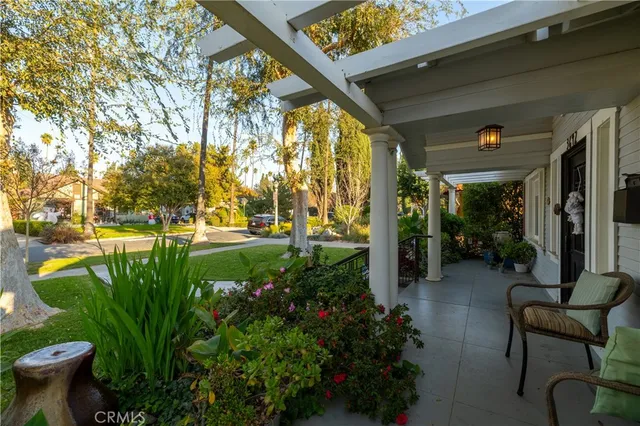 a view of a porch with chairs and plants