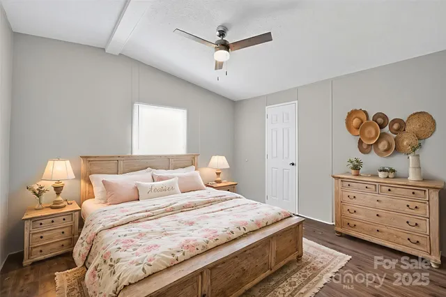 a bedroom with a bed and painting on the wall